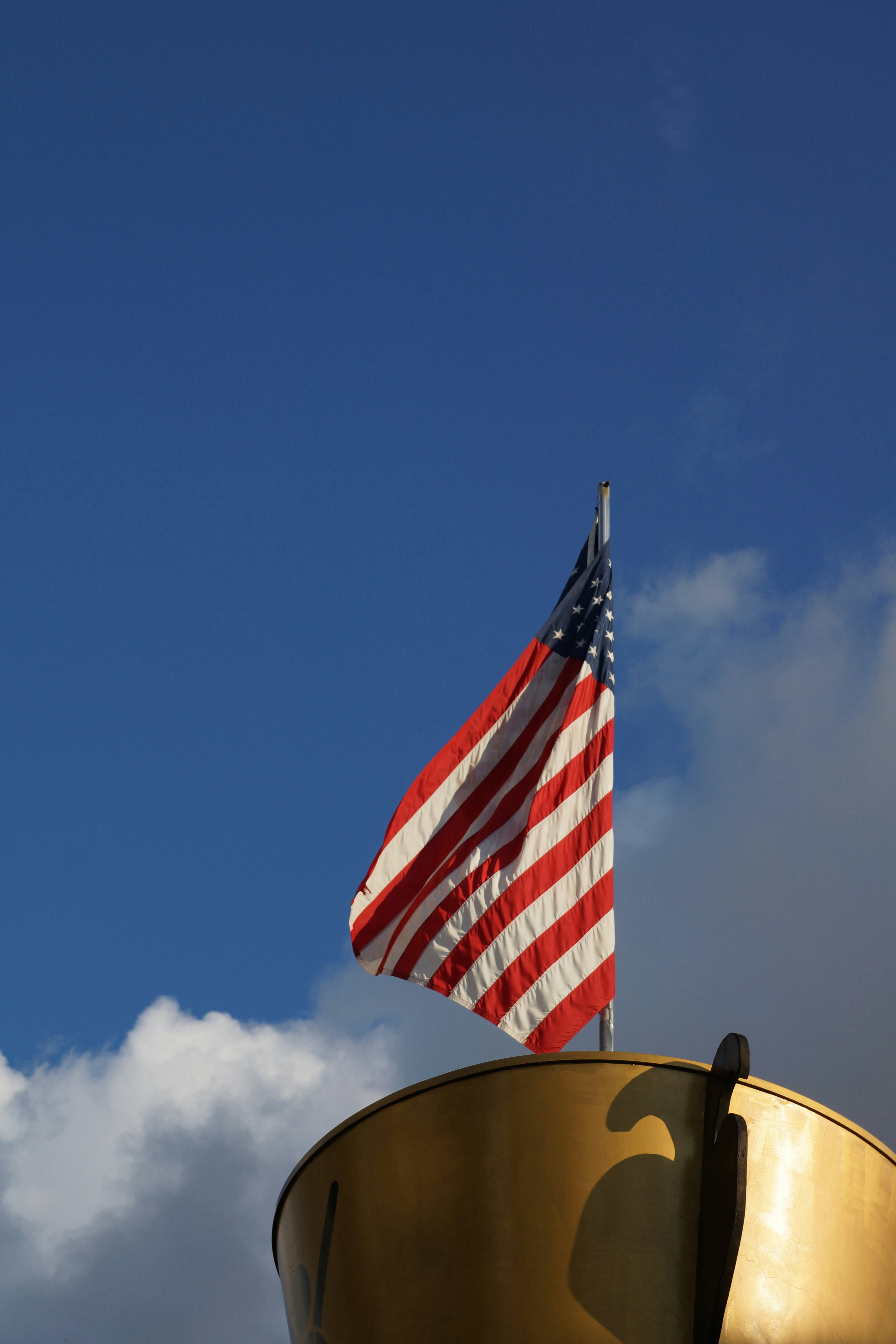 An american flag flying on top of a building